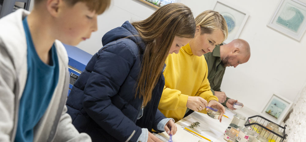 Family experiencing a craft workshop